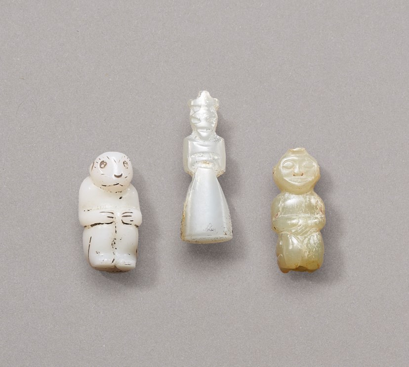 WHITE JADE HUMAN-FORM PENDANT (MIDDLE): WESTERN ZHOU DYNASTY (1100-771 BC) TWO SMALL JADE FIGURAL CARVINGS: WESTERN ZHOU DYNASTY OR LATER