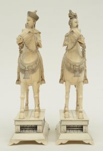 A pair of Chinese ivory figures of an imperial couple on horses,