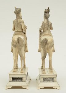 A pair of Chinese ivory figures of an imperial couple on horses,