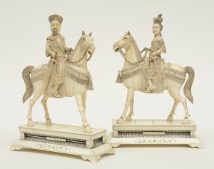 A pair of Chinese ivory figures of an imperial couple on horses,